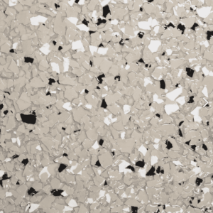 Dessert Clay epoxy floor flake sample showcasing a blend of light beige, white, and black colors, reflecting the aesthetic options available for Pristine Epoxy flooring solutions.