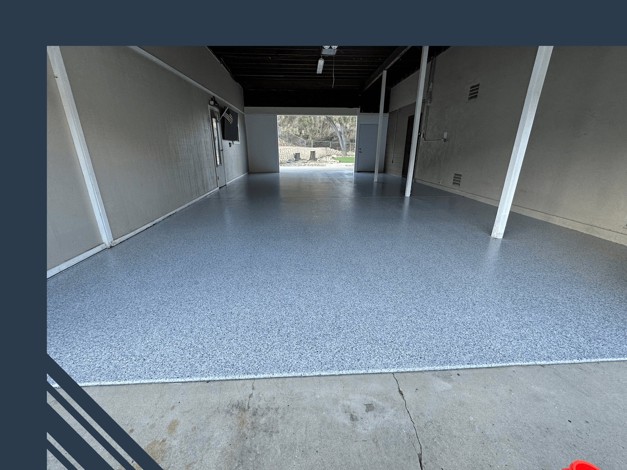 Epoxy-coated garage floor showcasing a glossy, stain-resistant surface enhancing interior brightness, reflecting Pristine Epoxy's commitment to quality flooring solutions.