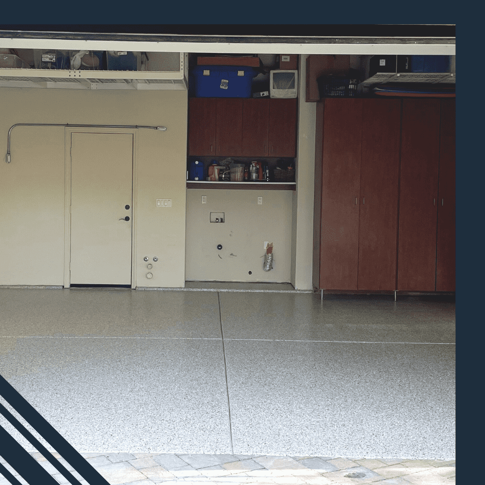 Garage interior featuring newly installed epoxy flooring, storage cabinets, and a side door, showcasing Pristine Epoxy Floor Coatings' transformation capabilities for residential spaces.