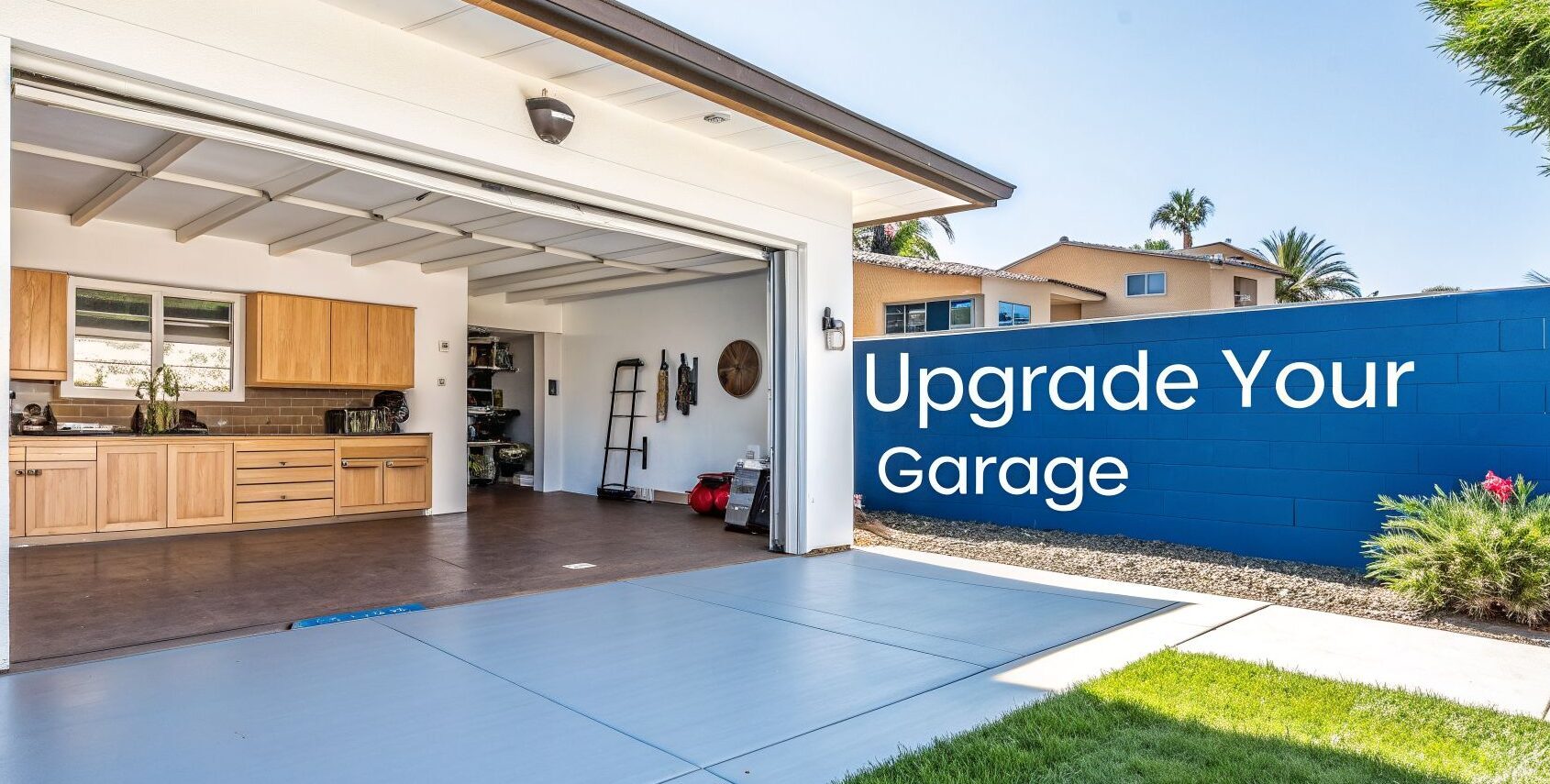 Upgraded garage interior with modern cabinetry, open layout, and a blue accent wall featuring the text "Upgrade Your Garage," emphasizing garage transformation potential in San Diego.