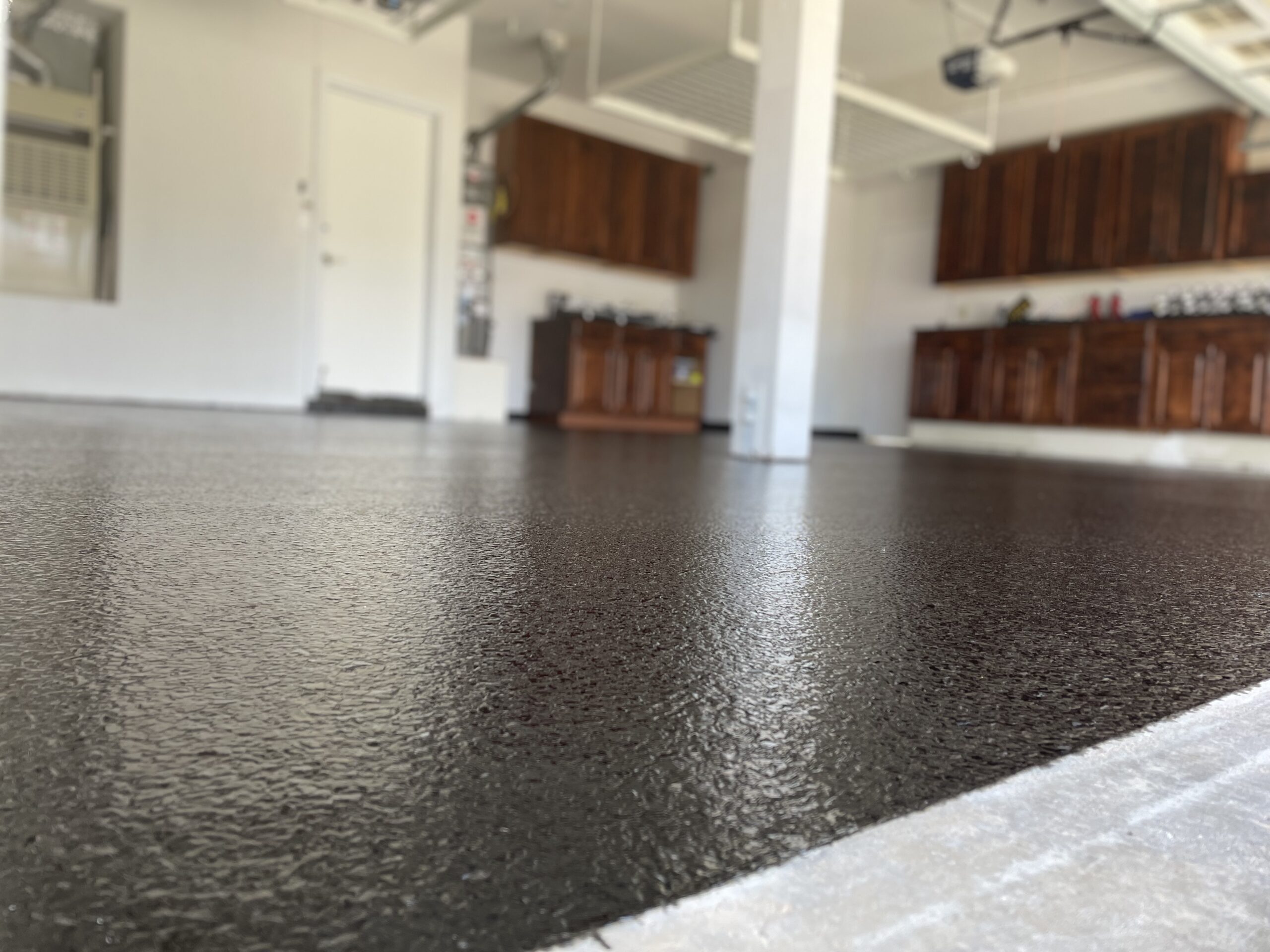 Stylish epoxy flooring transforming a garage from bland to grand.